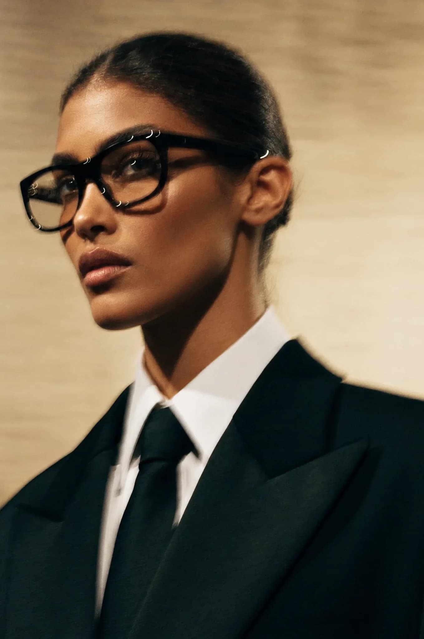 Portrait with black glasses, a suit and tie