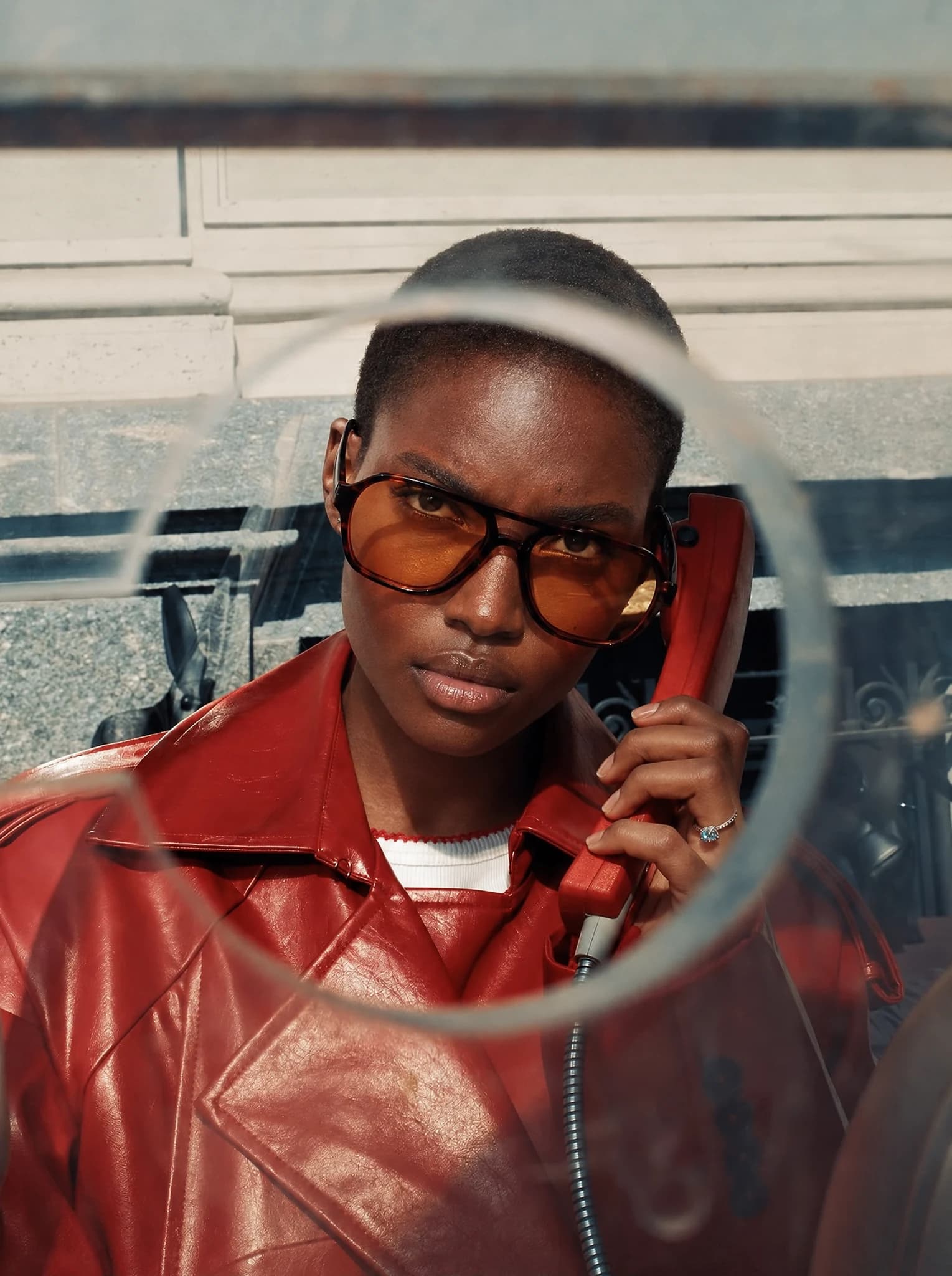 Portrait with amber glasses and a red telephone